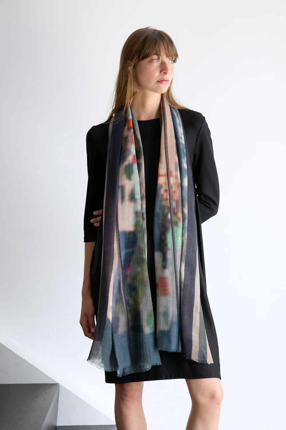Wool Scarf mulitcoloured with blues, greens, oranges and yellow. Model.