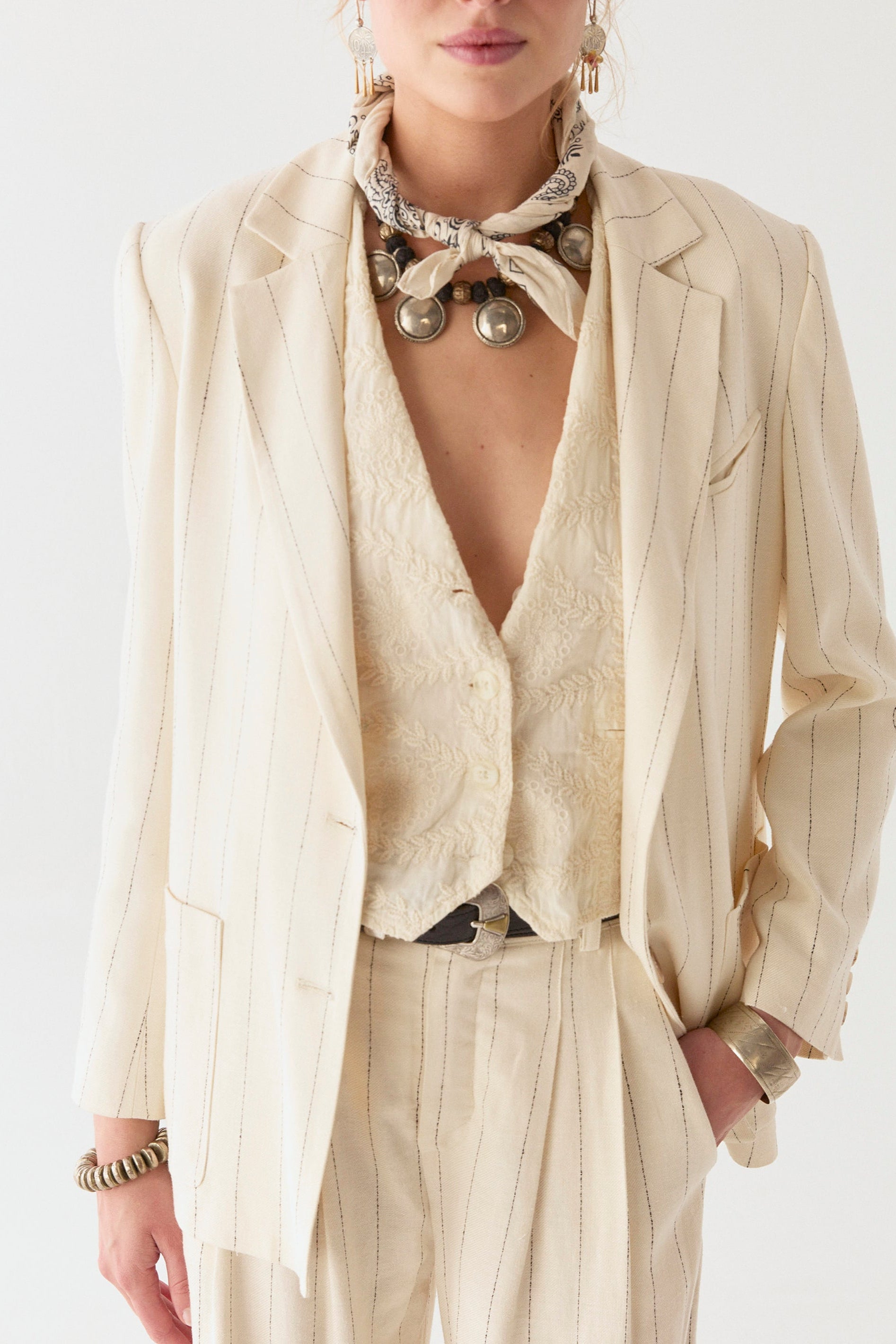 Model wearing linen cotton blend blazer in cream with navy stripe on a white background.