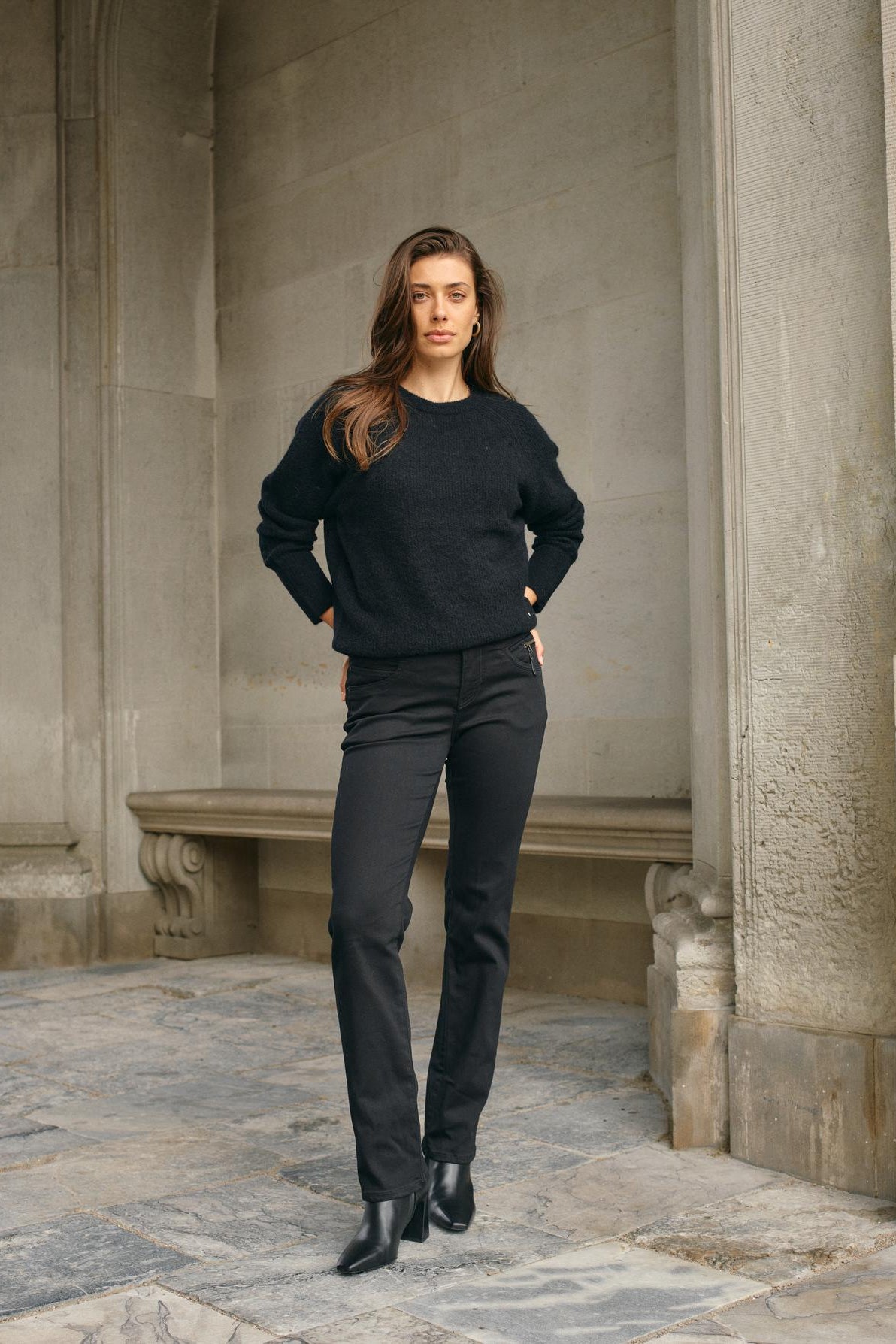 Black tapered jean with mid rise and zip detail at left front pocket.
