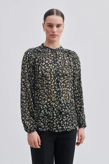 Floral shirt on black base, long sleeves. Stand up collar and button through fastenting, piped shoulder and yoke at the back. 