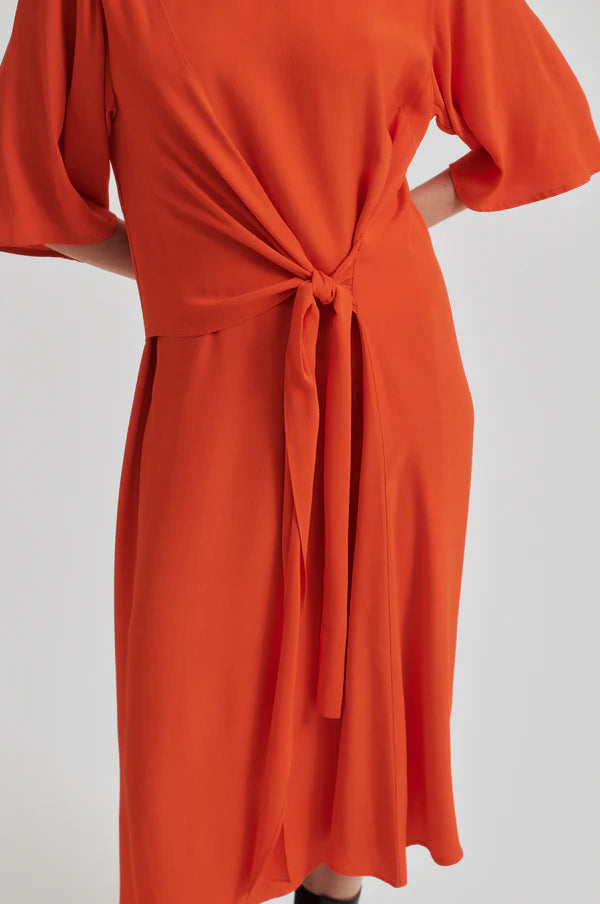 Orange short sleeve dress dress with a tie waist on a white background