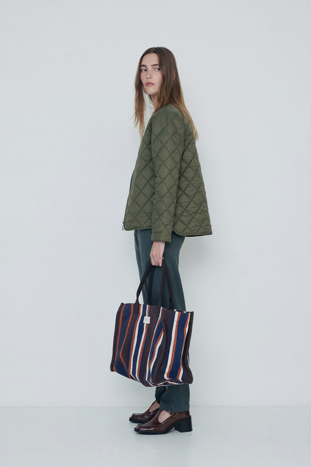 Khaki quilted long sleeve jacket with front zip.