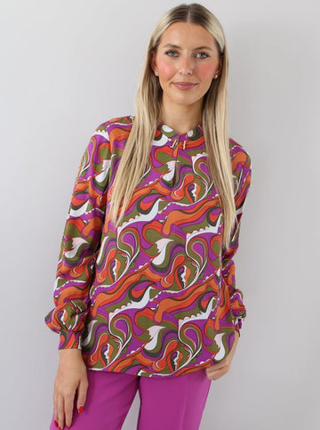 vibrant 70s style long sleeve shirt with purple white green orange and red pattern. 