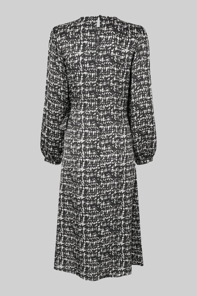Monochrome long sleeve dress with crossover front that ties to one side.