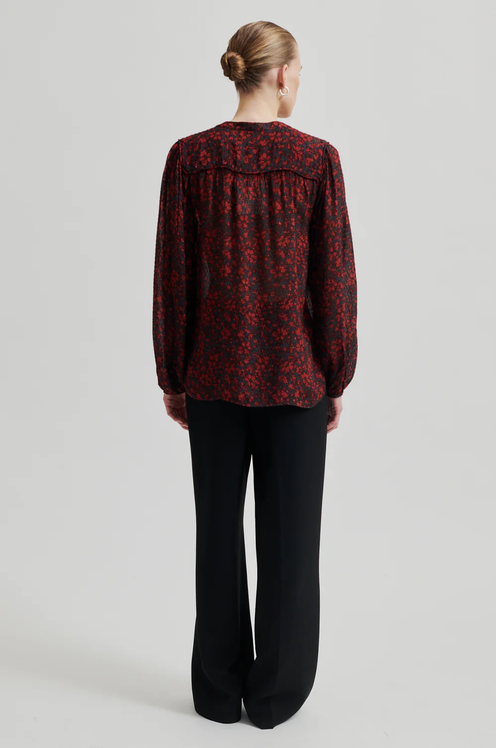 Loose fitting semi sheer shirt with pattern. Red and Black tonal. Back of shirt. 