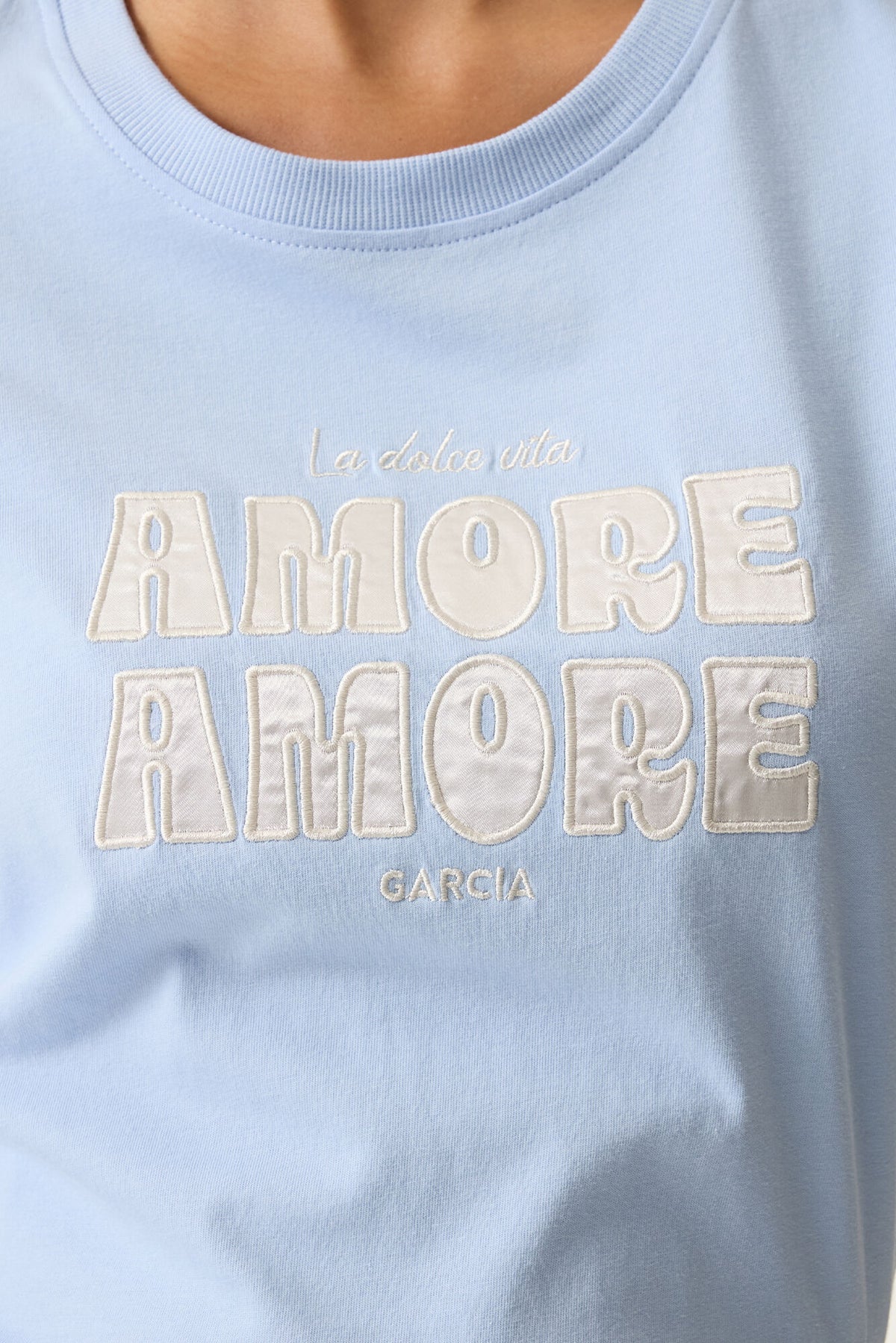 Light blue tee shirt with 'AMORE AMORE' text and 'Garcia' branding.