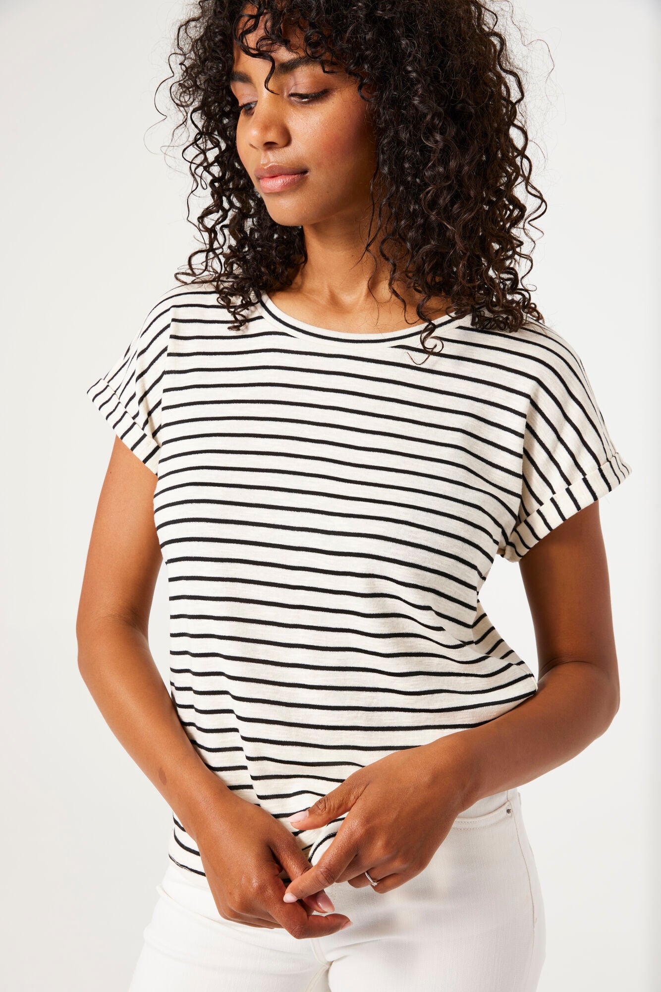 Woman wearing a black and white striped t-shirt against a plain background