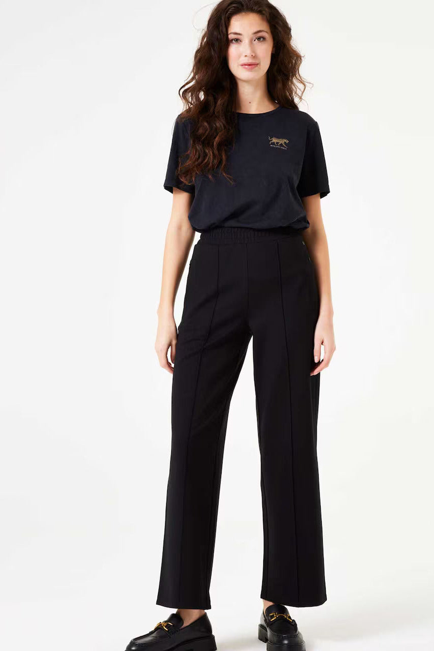 Person wearing a black pants and a black t shirt on a white background