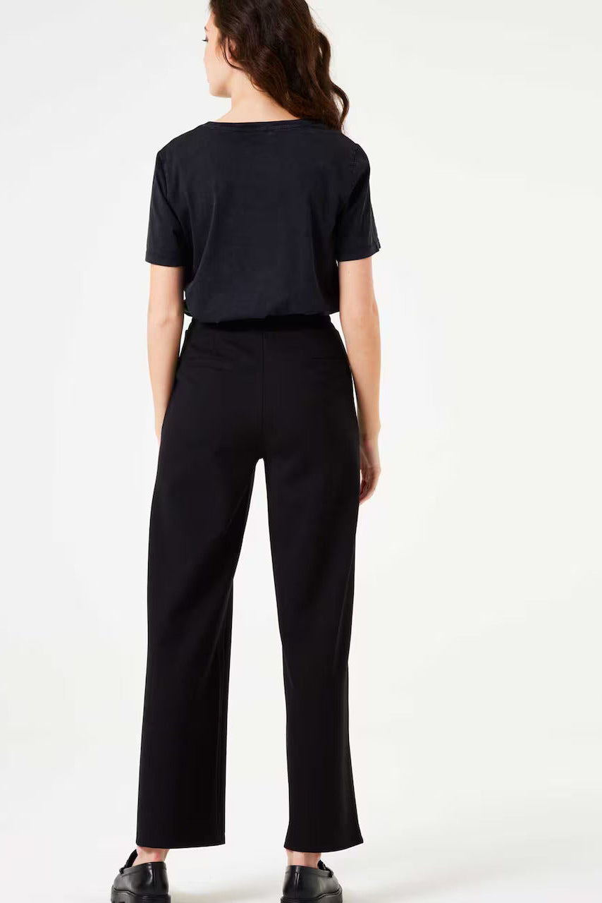Person wearing a black pants and a black t shirt on a white background