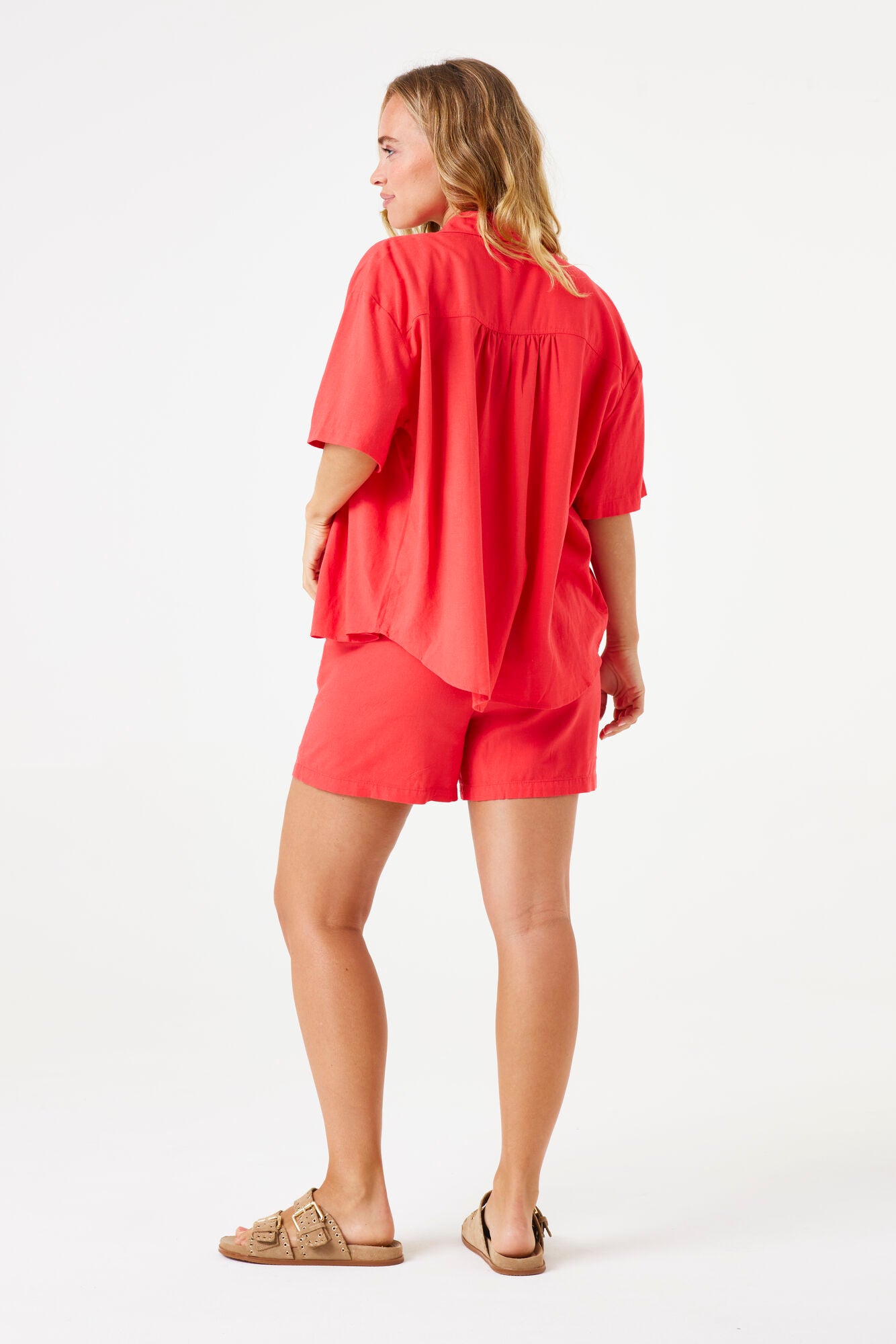 Woman wearing a red outfit on a white background