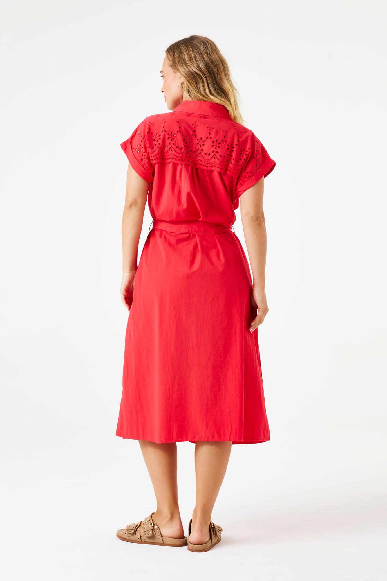 Model wearing short sleeve ruby red midi dress with broderie top. 