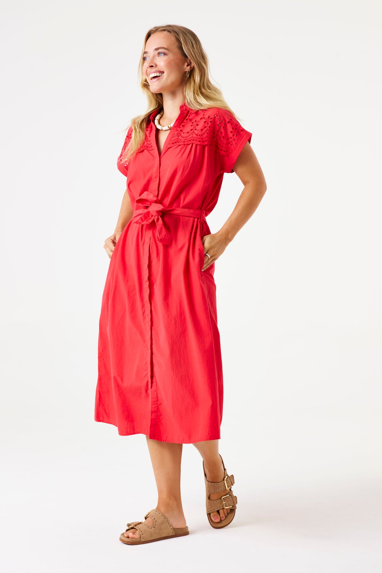 Model wearing short sleeve ruby red midi dress with broderie top. 