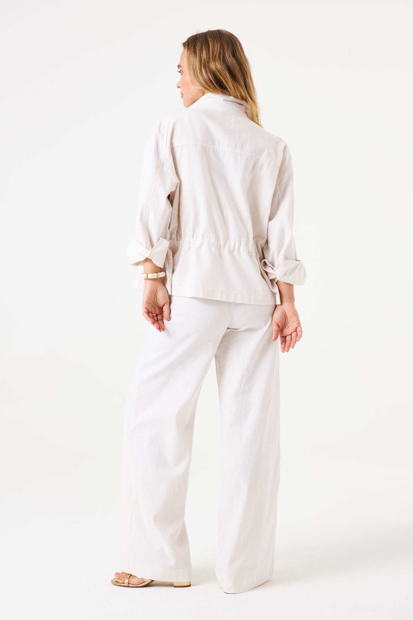 Woman wearing a white outfit on a white background