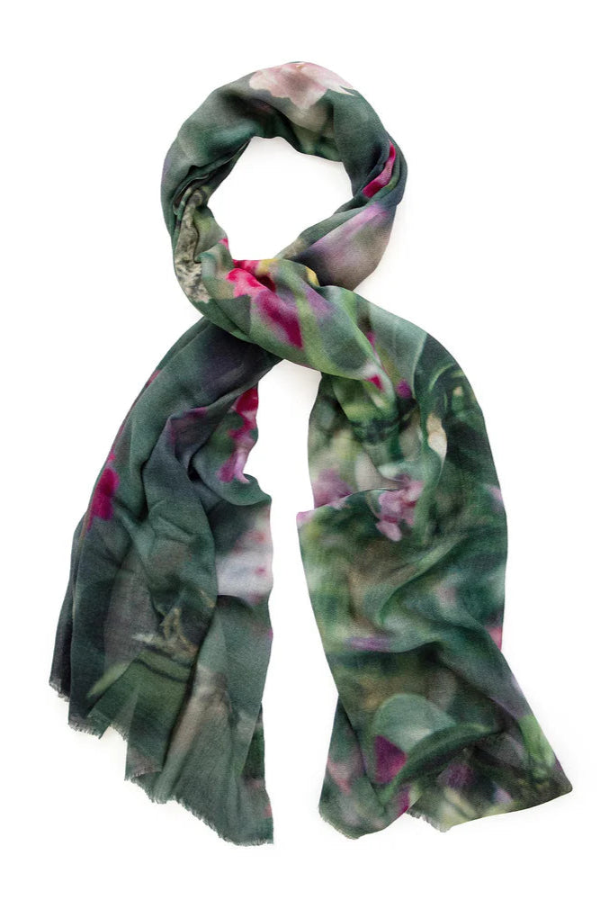 Colourful floral print wool scarf with green base and purple and pink detail. 