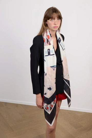 Multi coloured square cashmere blend scarf in navy and pink tones with all over print.  Model. 