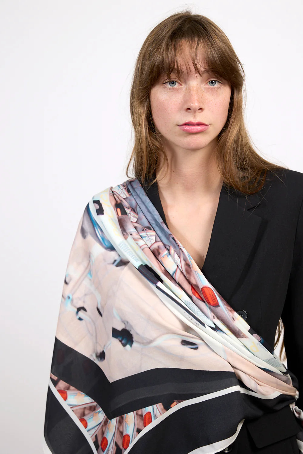 Multi coloured square cashmere blend scarf in navy and pink tones with all over print.  Model. 
