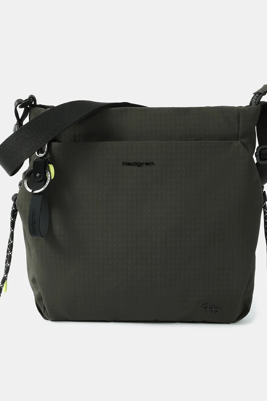 A dark olive green crossbody bag by Heidigreen, featuring a textured fabric body, a black adjustable shoulder strap, and small neon yellow-green accents on the drawstring tips and keychain ring, shown against a light gray background.