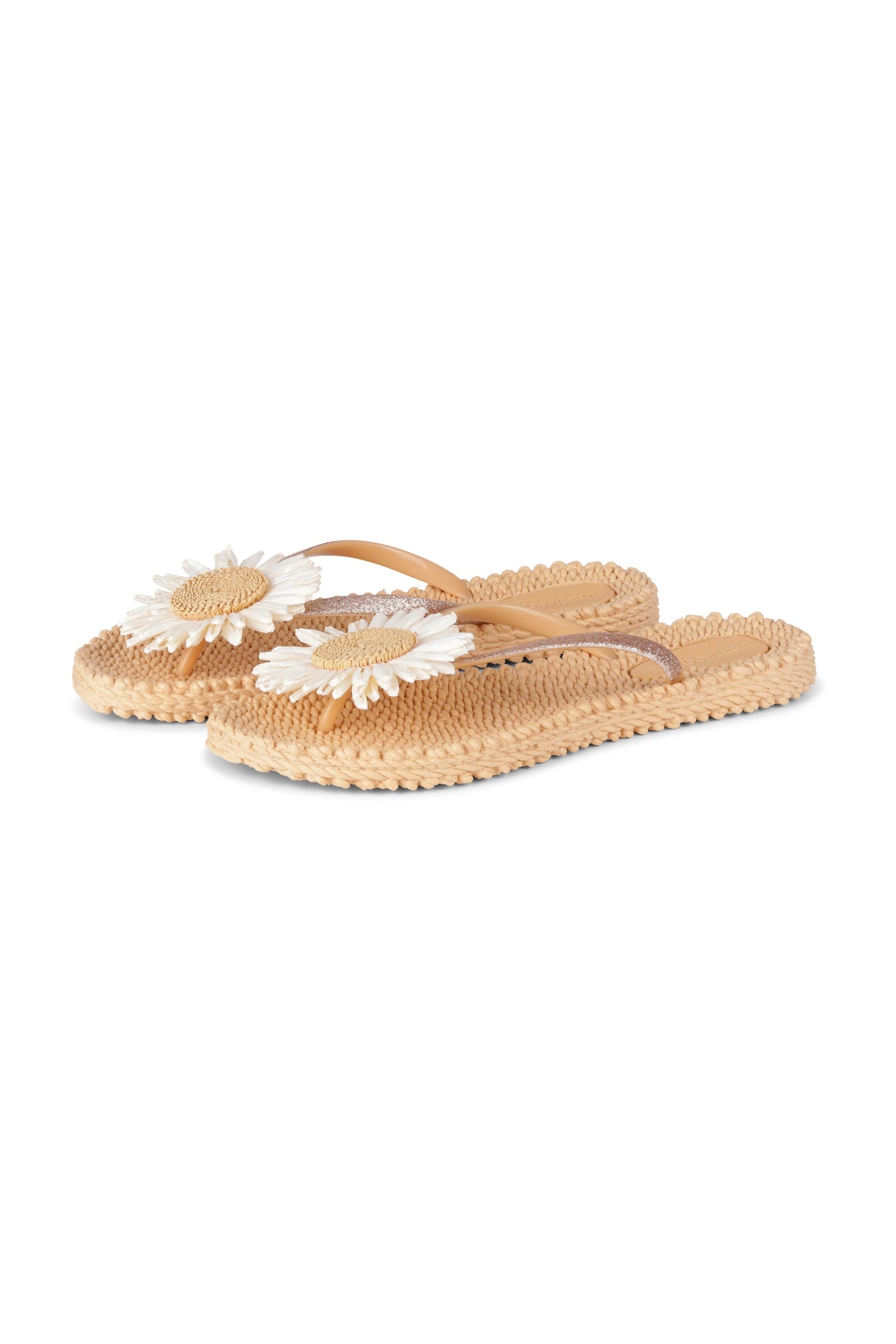 Pair of beige sandals with white floral straps on a white background