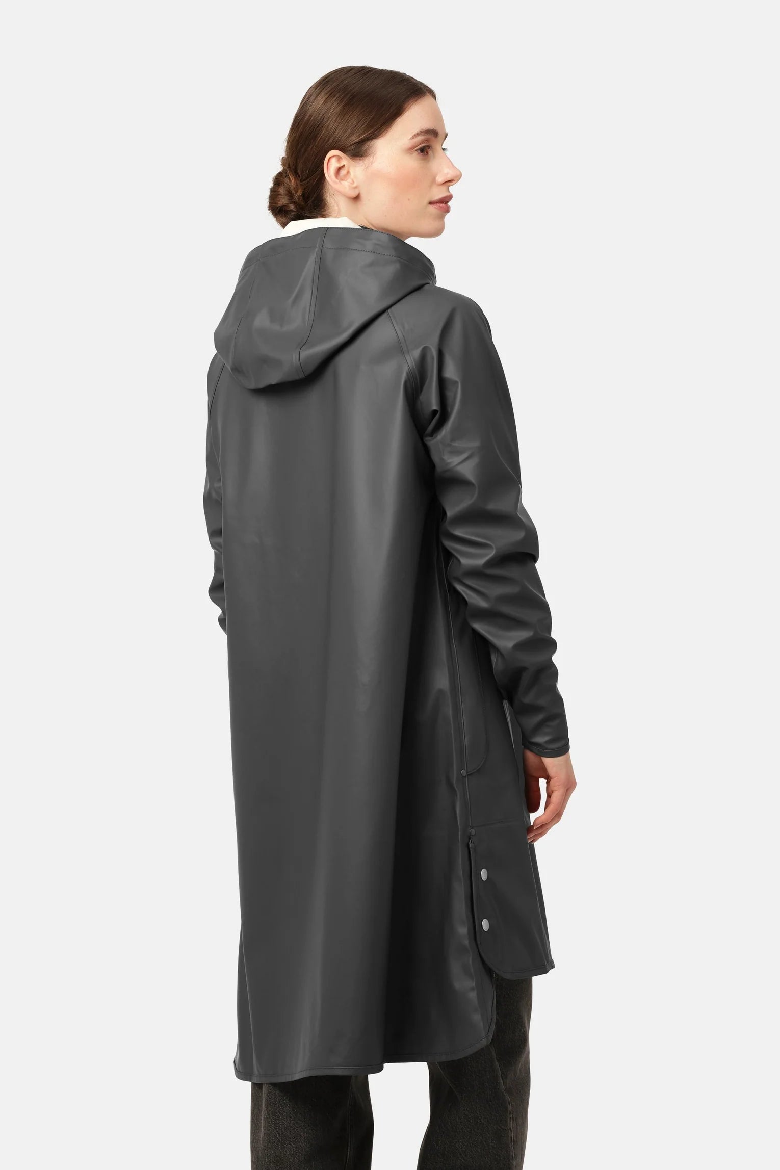 Knee length black rain coat with hood and hidden press buttons.