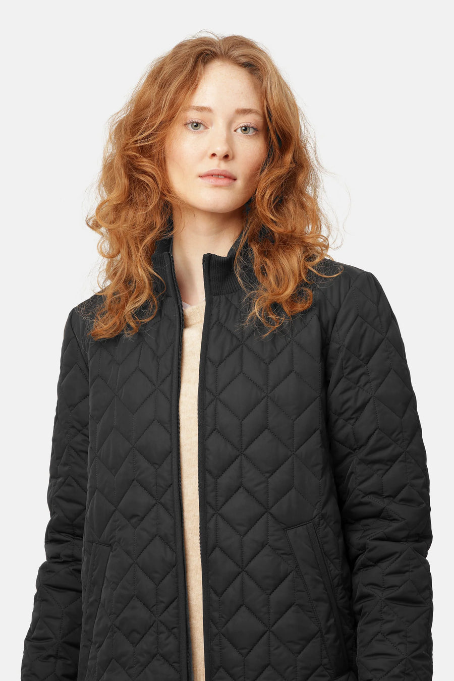 black quilted jacket with mock neck and front zip. 