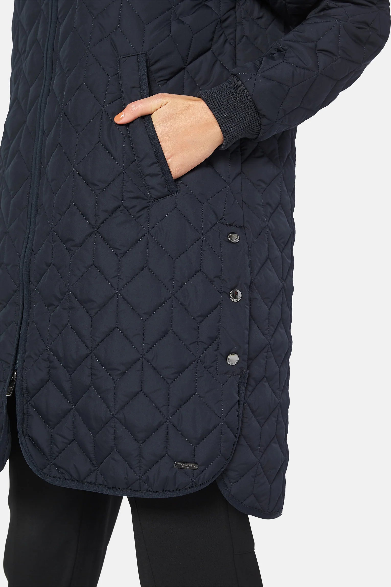 Quilted knee length coat with silver stud detail at splits. 