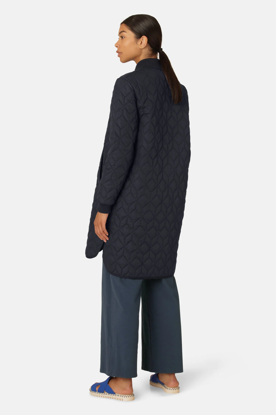 Padded quilted jacket knee length in dark indigo colour with mock neck. 
