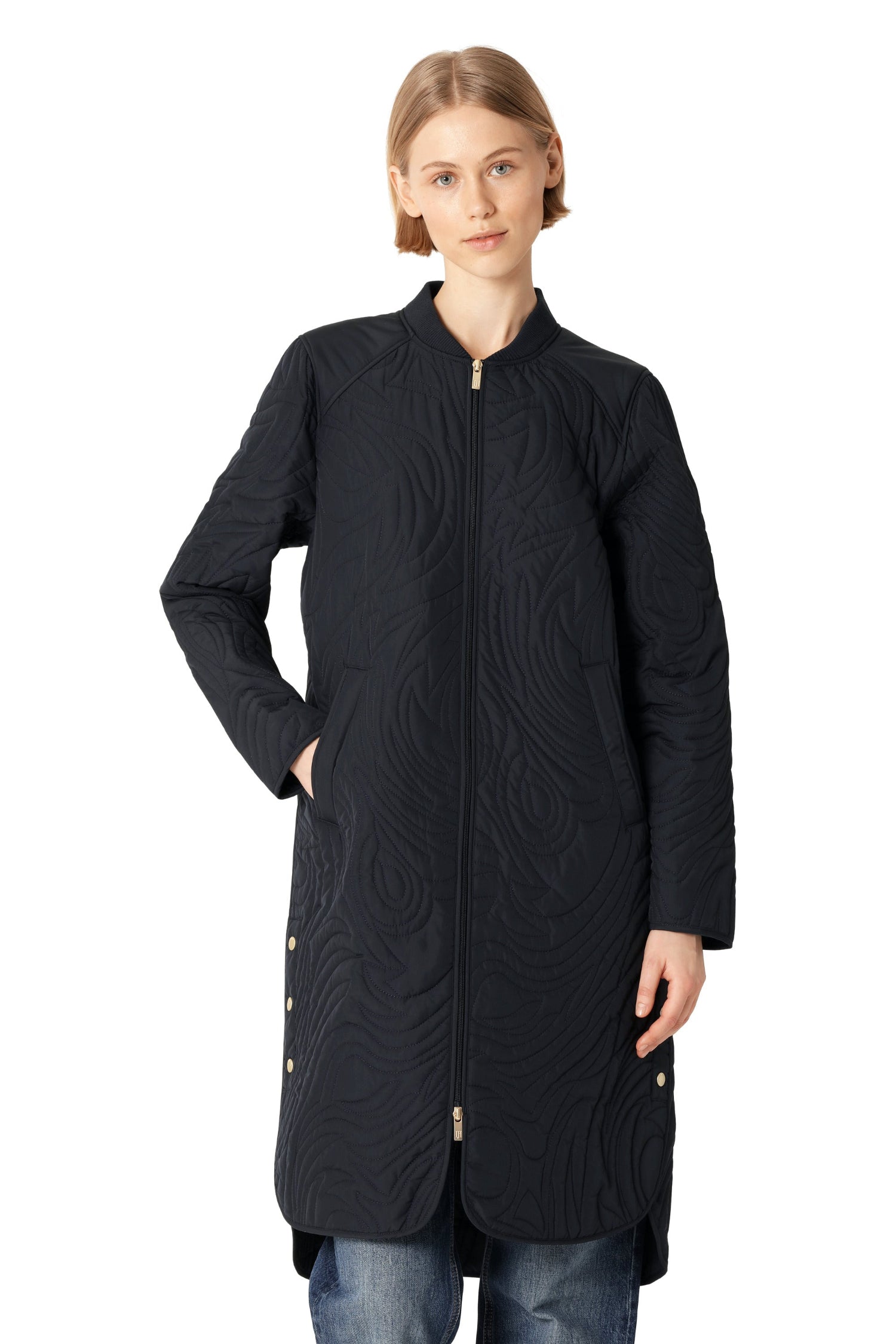 Woman wearing a black quilted coat on a white background