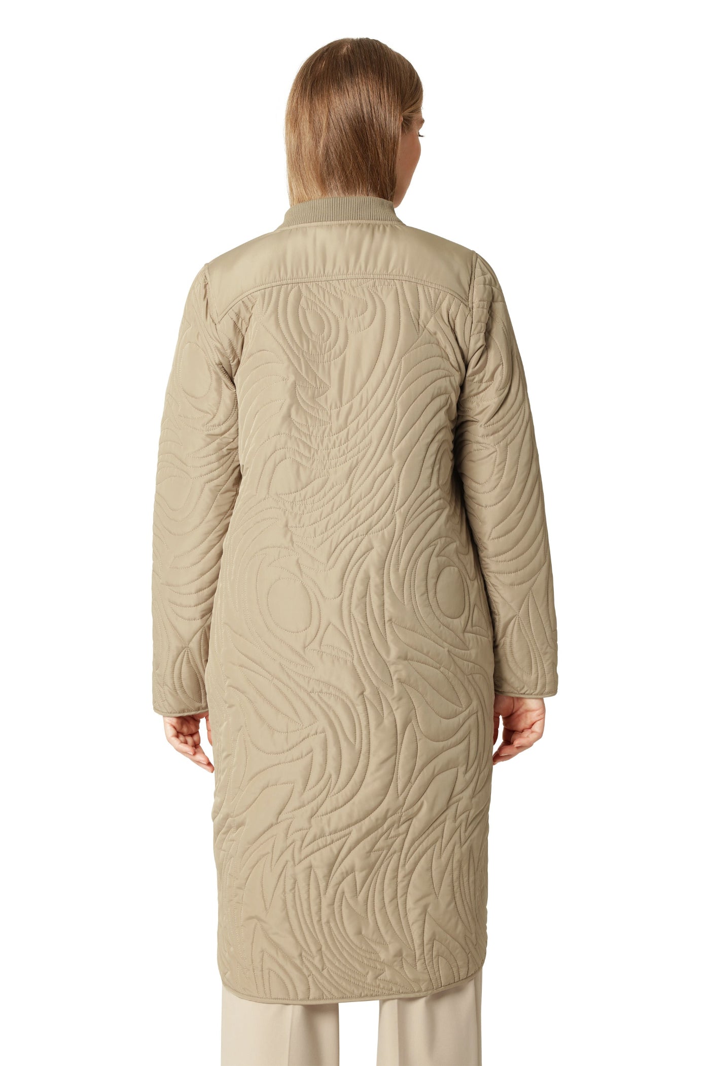 Beige quilted coat worn by a person on a white background