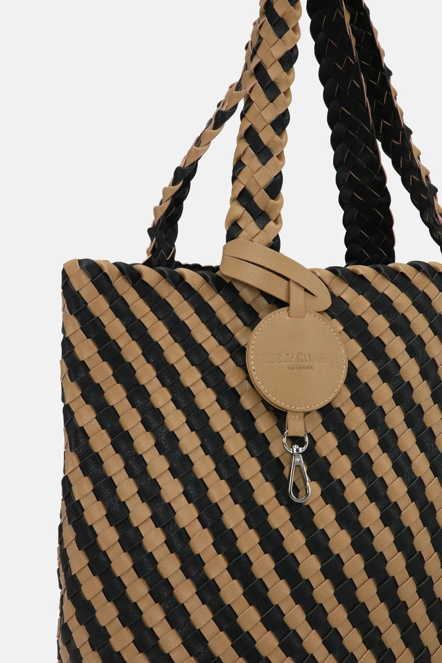 Woven bag with black and beige pattern on a white background