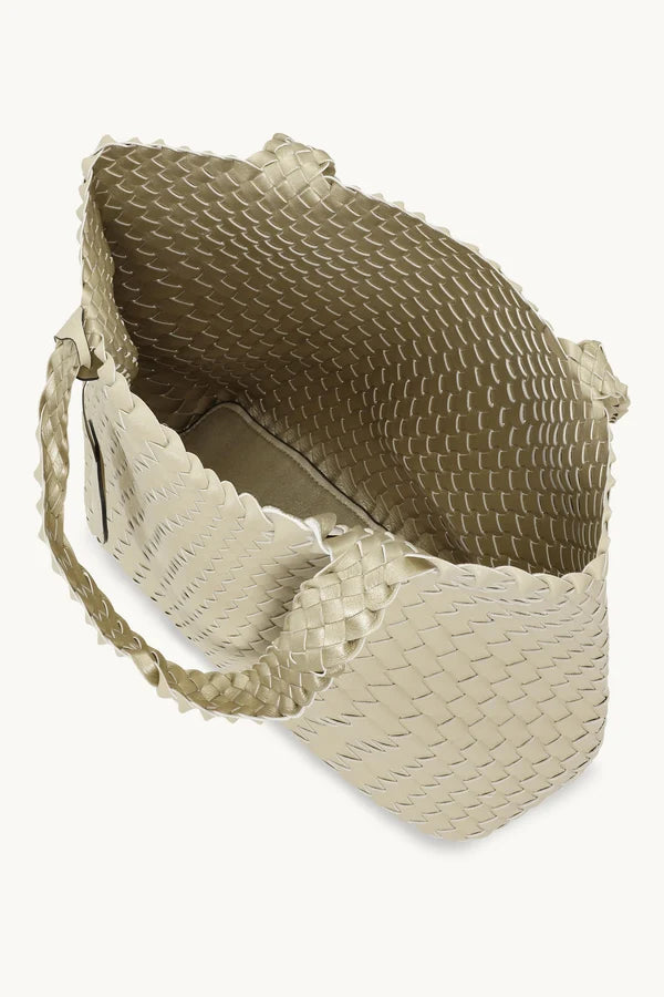 A light ivory woven  tote bag with braided shoulder straps and a round hanging tag, shown against a plain white background.