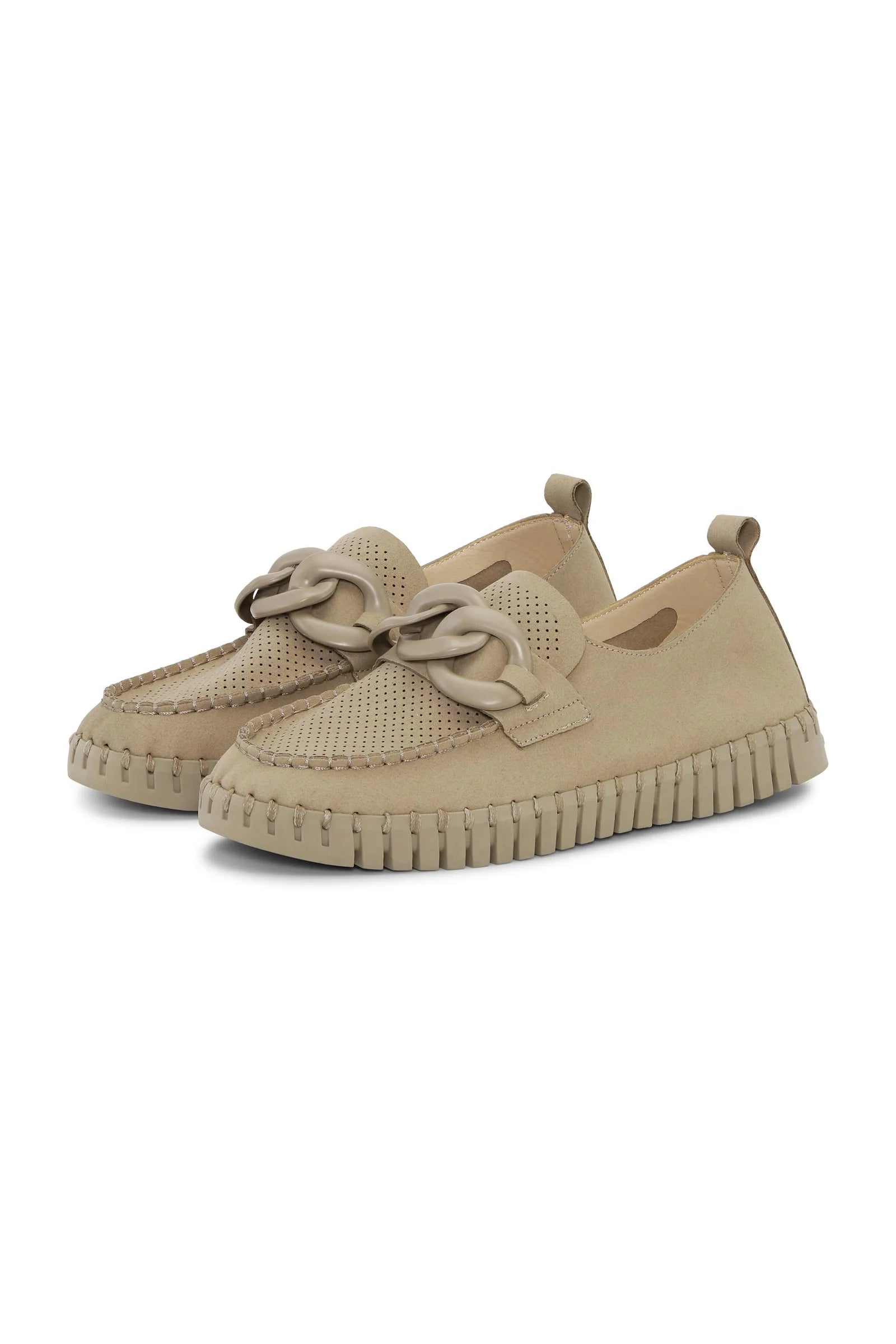 Beige womens slip on shoes with rubber sole deatail on a plain background. 
