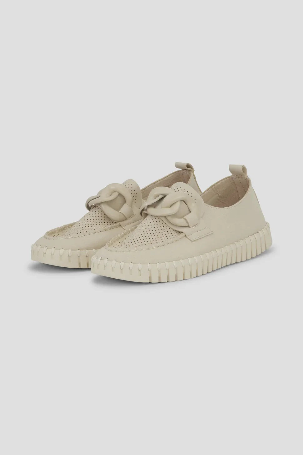A pair of beige slip-on loafers with textured knit detailing and thick ridged soles, shown from a three-quarters angle on a light background.