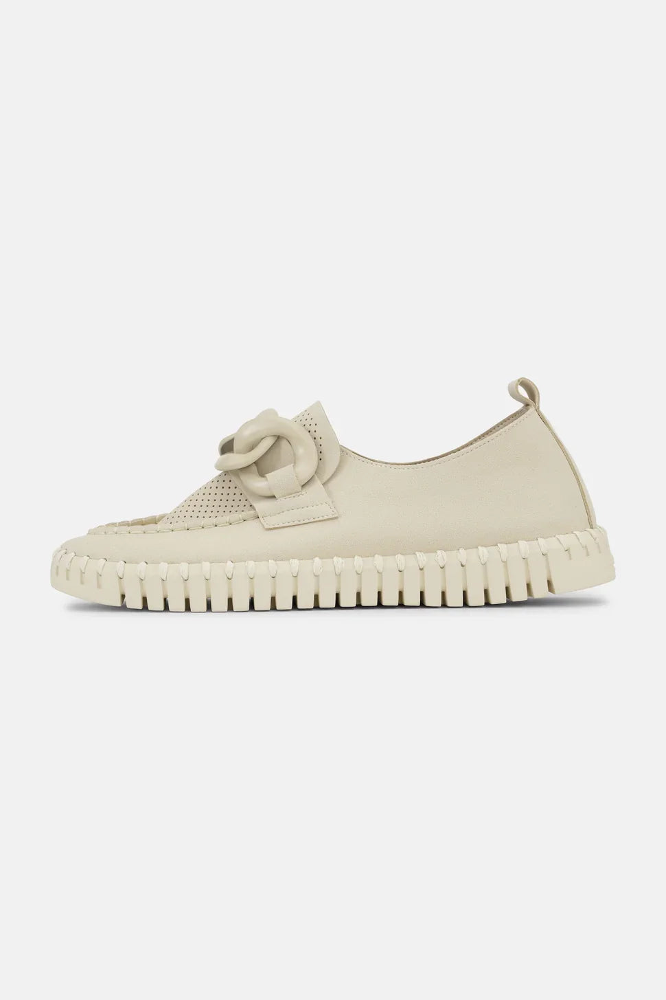 A  beige slip-on shoe with textured knit detailing and thick ridged soles, shown from the side on a light background.