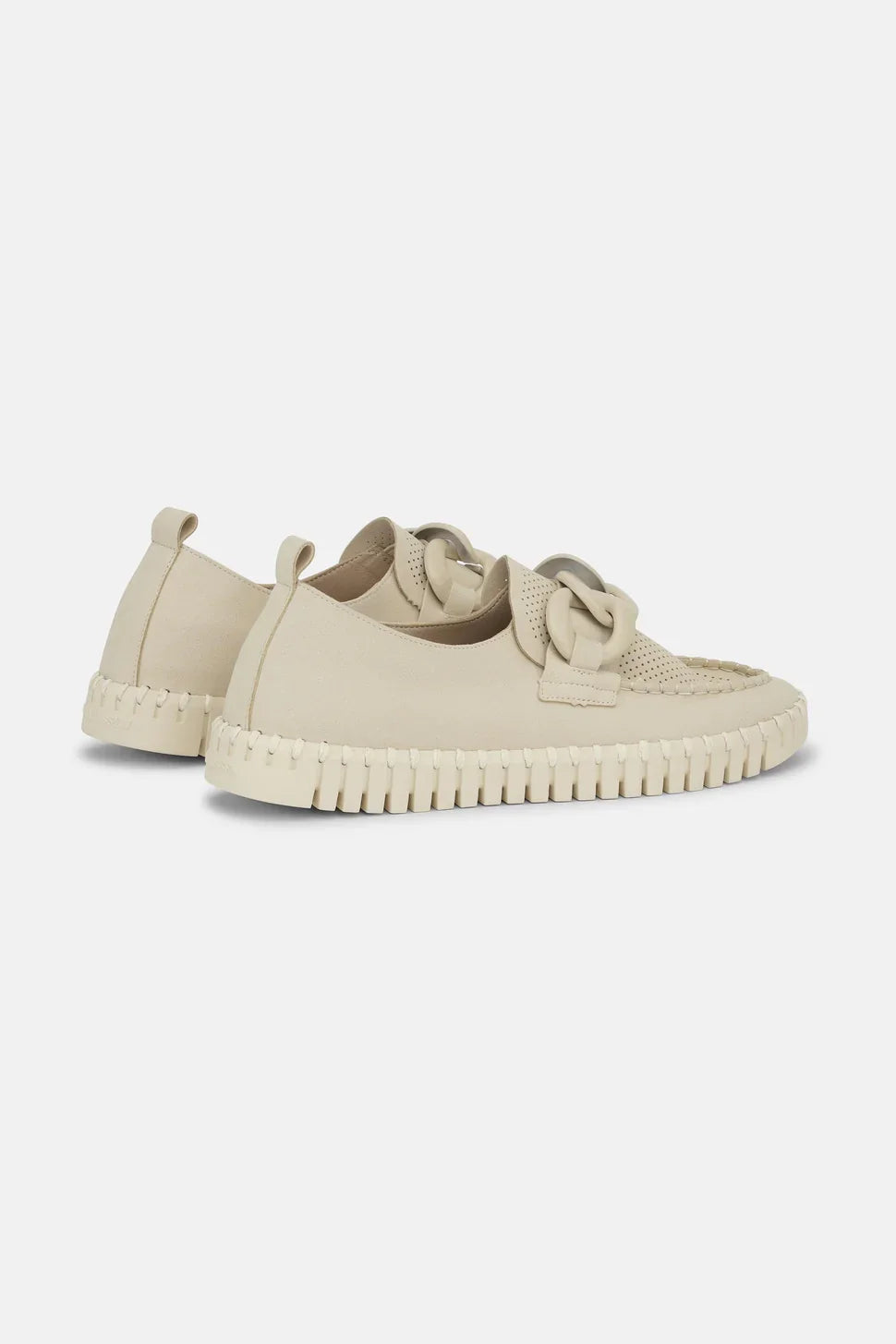 A pair of beige slip-on sneakers with textured knit detailing and thick ridged soles, shown from a three-quarters angle on a light background.