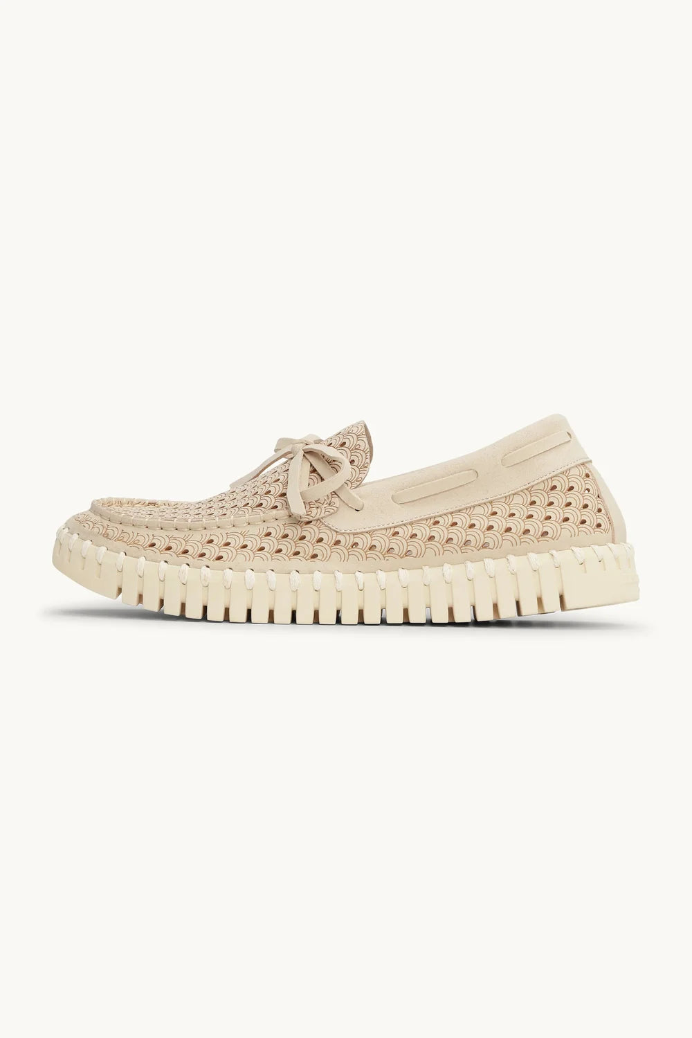 A single beige woven slip-on loafer with a matching fabric tie detail on the vamp and a thick, textured off-white sole, shown against a plain off-white background.