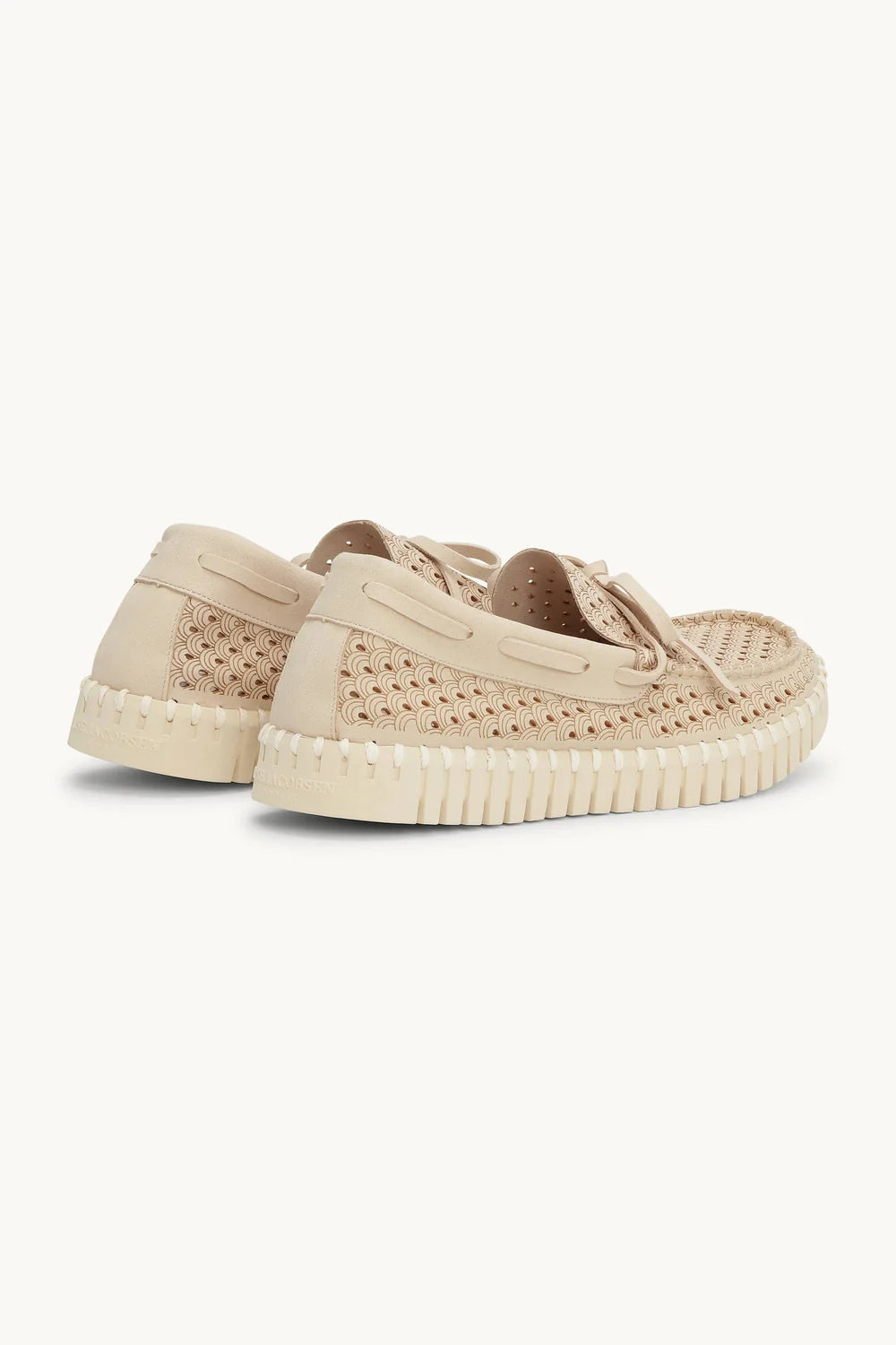 Beige sneakers with a textured sole on a white background