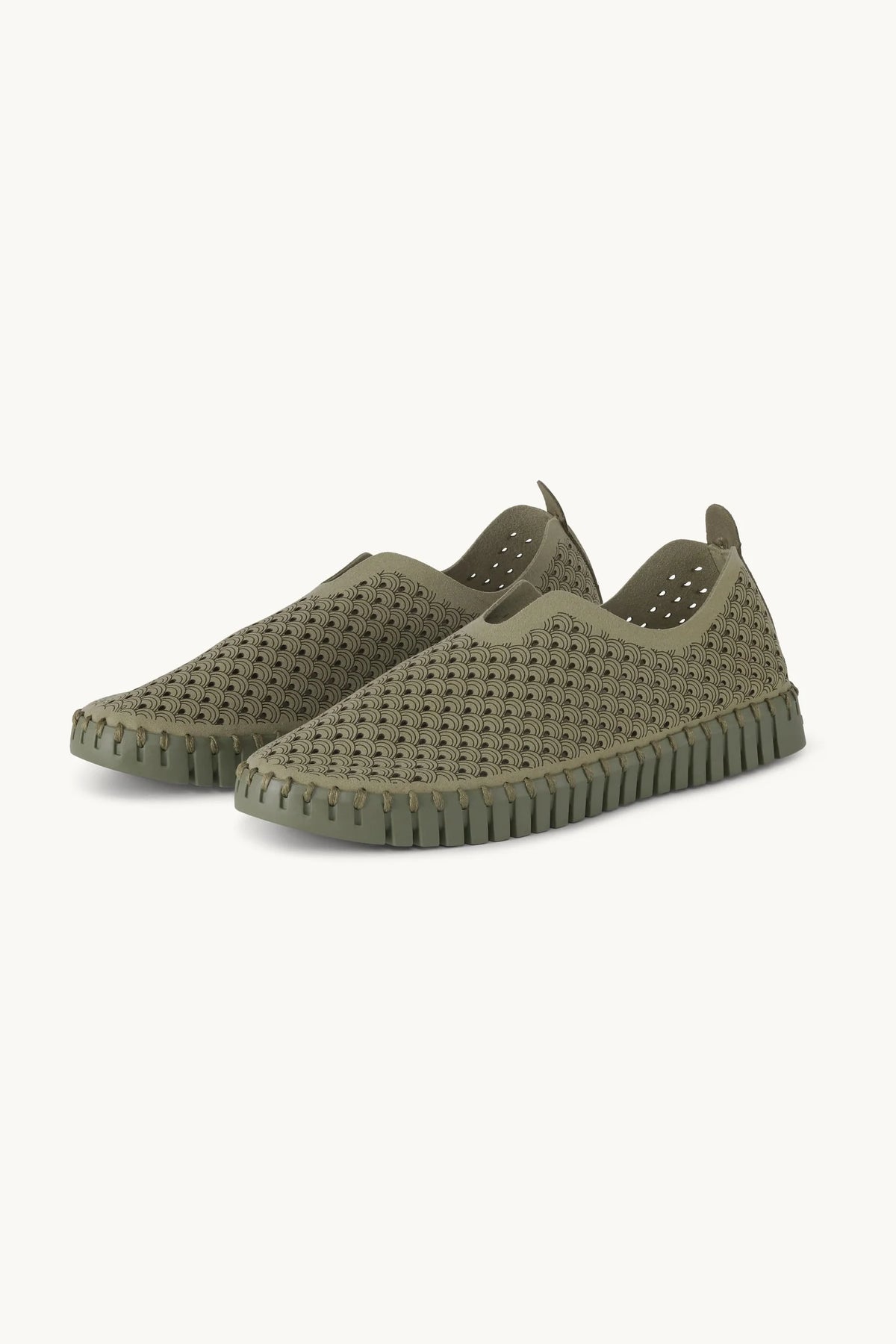 A pair of slip on Tulip shoes by Isle Jacobsen in olive green with slightly darker sole on a plain background. 