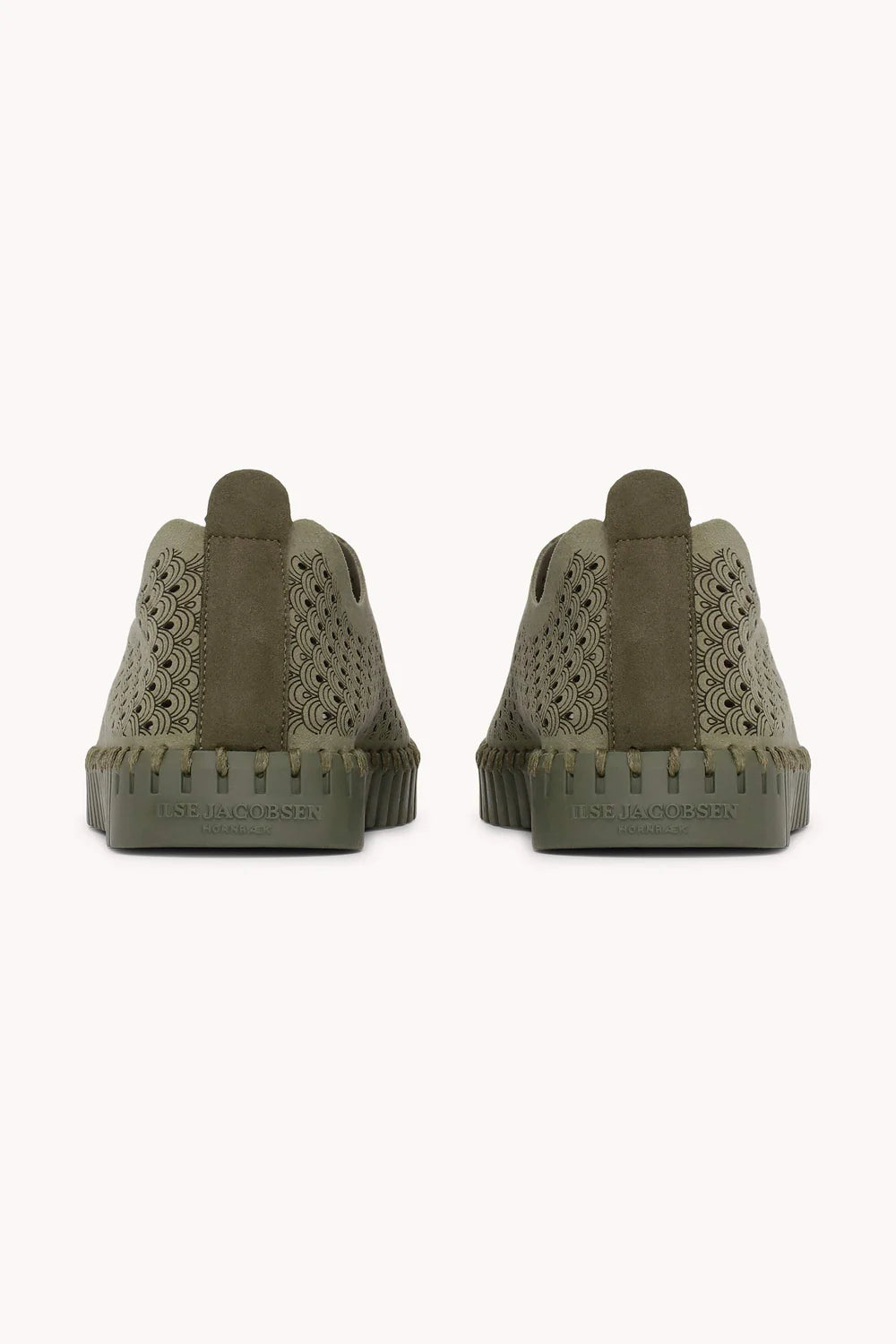 A pair of slip on Tulip shoes by Isle Jacobsen in olive green with slightly darker sole on a plain background. 