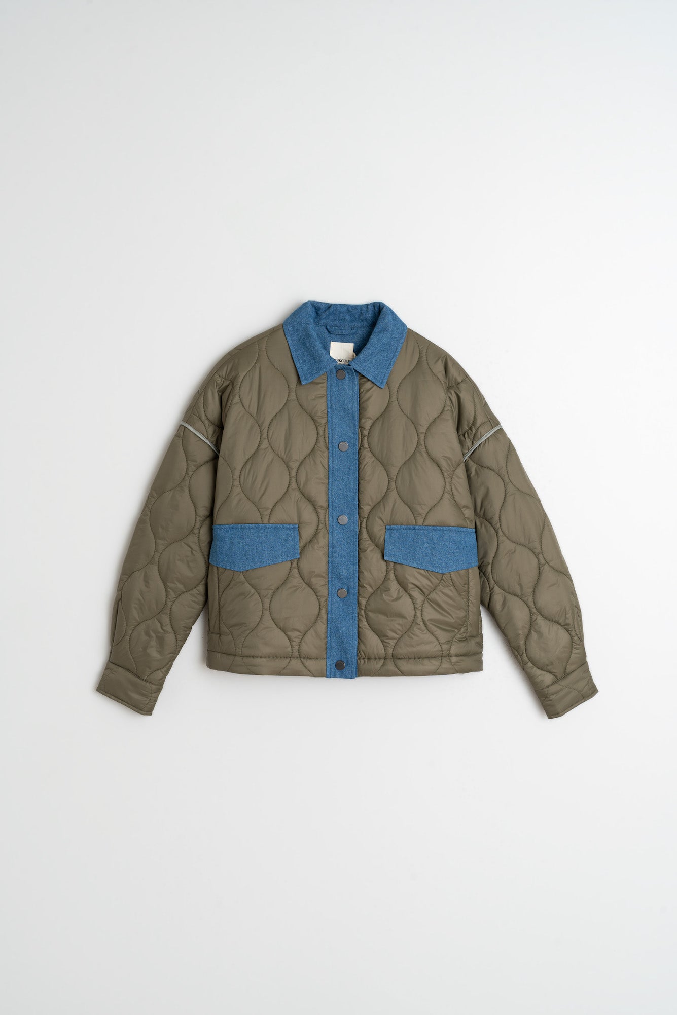 Green quilted jacket with blue accents on a white background