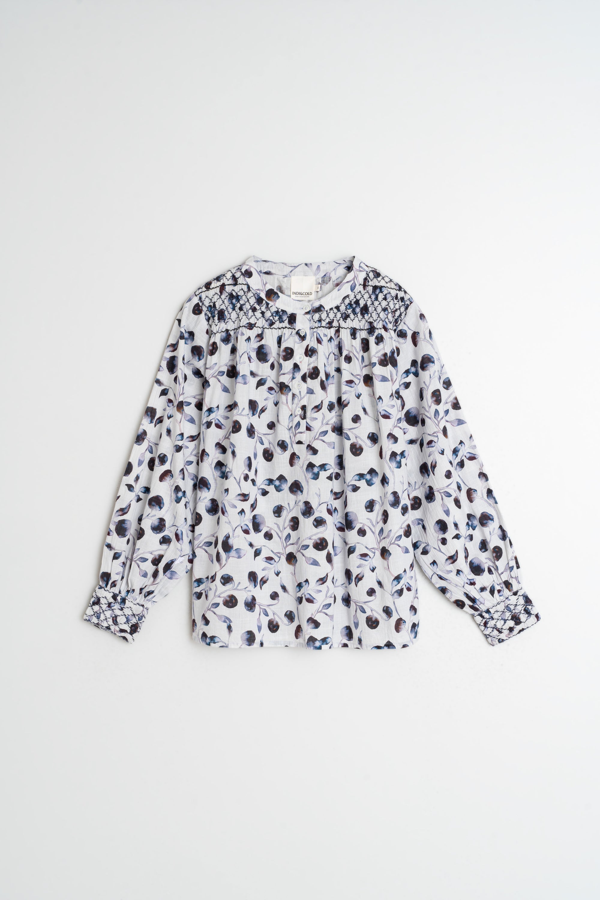 White blouse with black floral pattern on a white background