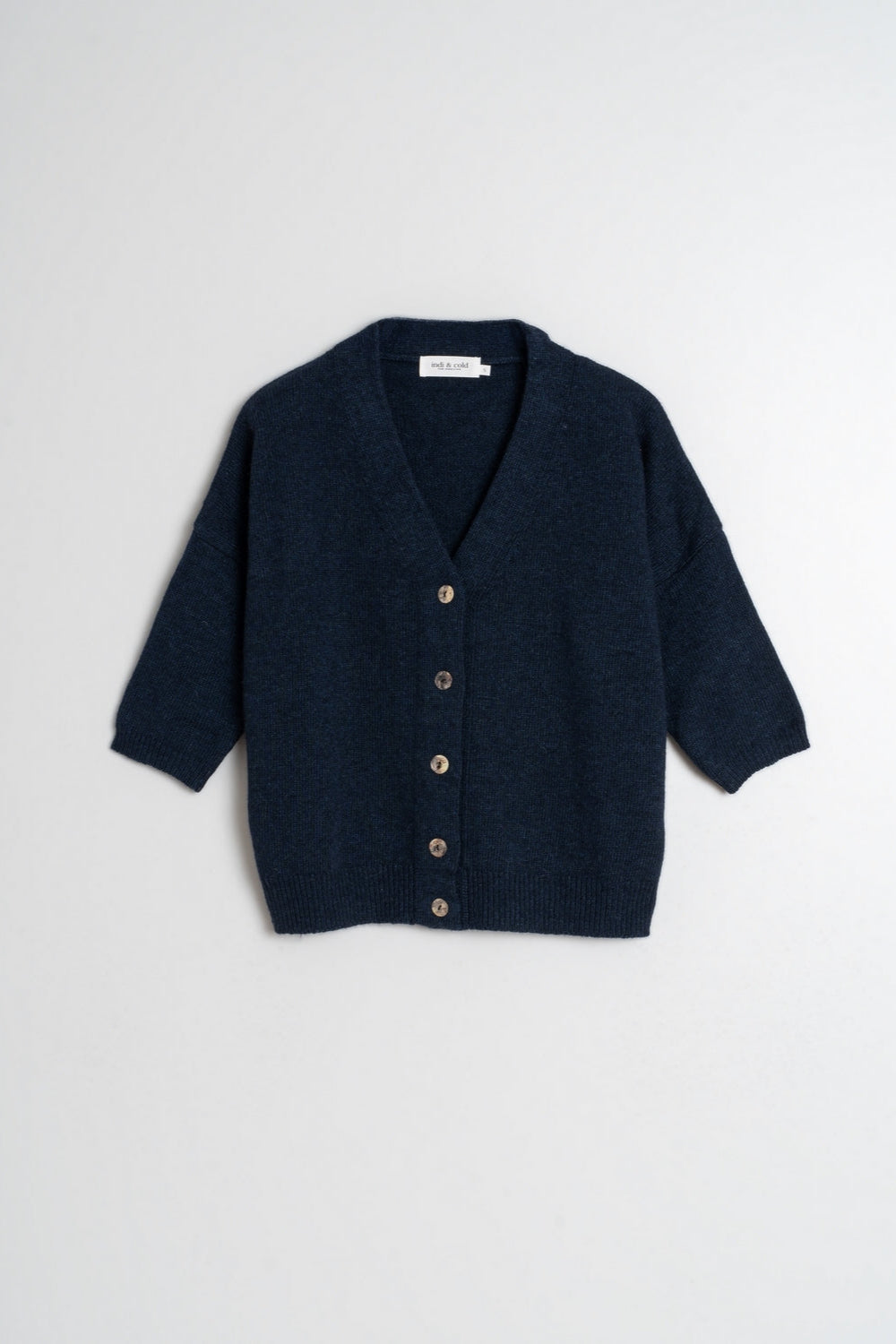 Navy short sleeve wool cardigan with front buttons, dropped shoulder and ribbed hem and cuffs. 
