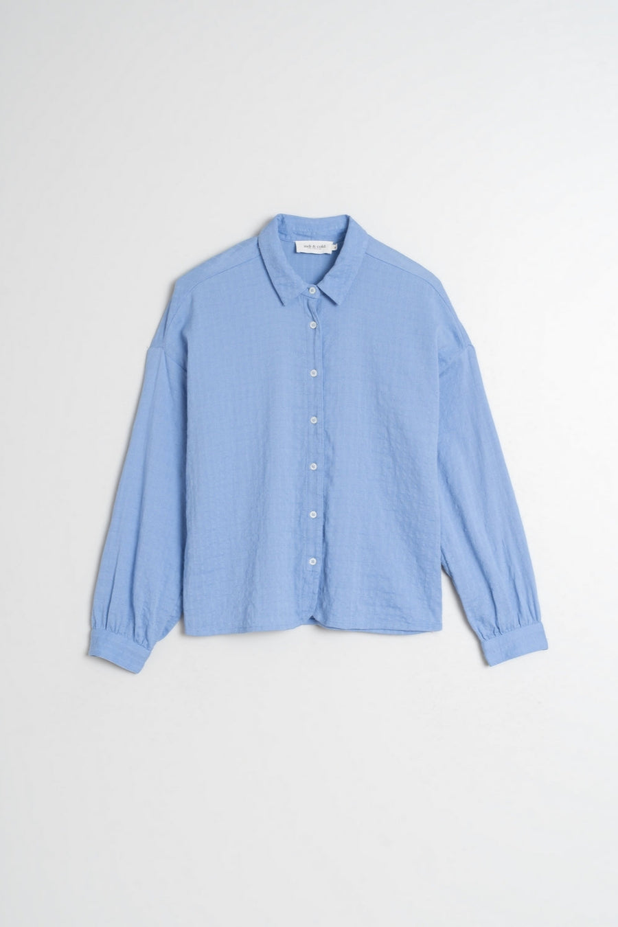 Blue Cotton Shirt with classic collar and dropped shoulder. White buttons and wide sleeves. 