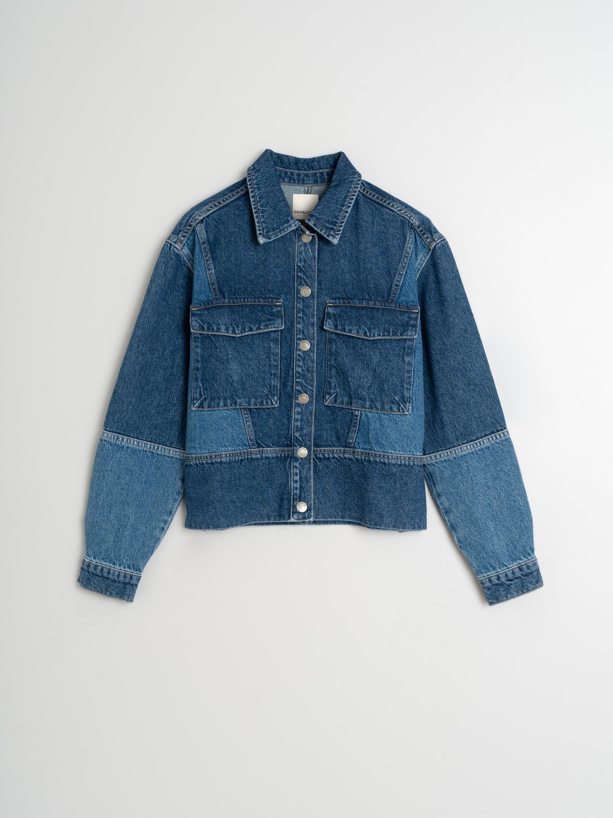 Blue denim jacket on a light gray background