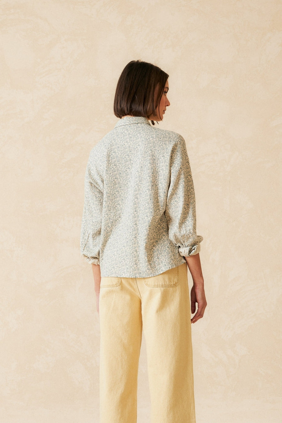 Organic Cotton Long sleeve shirt with beige base and delicate floral print. Back. 