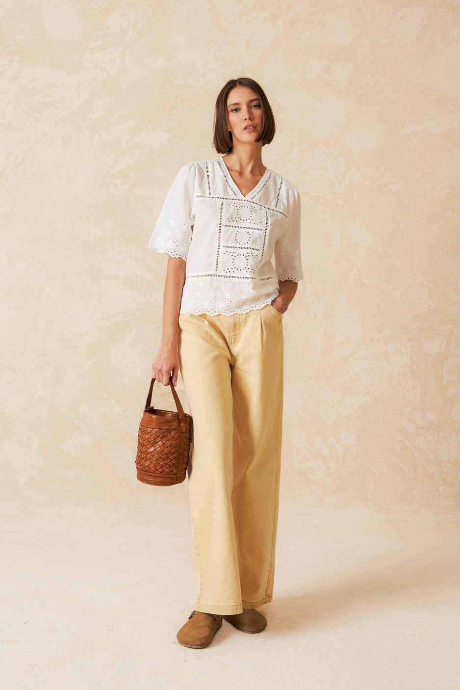 Short sleeve white v neck shirt with lace detailing. 