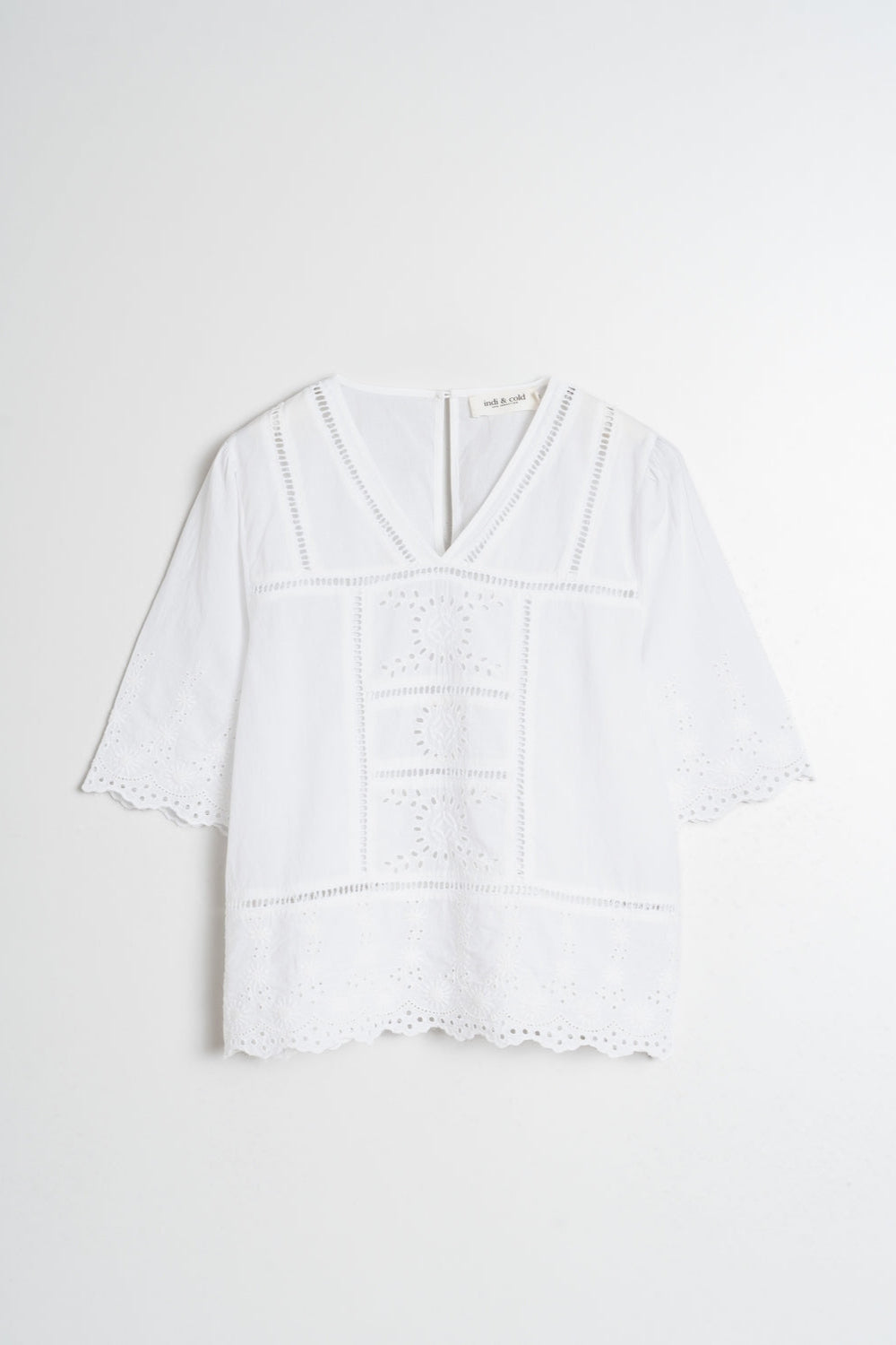 Short sleeve white v neck shirt with lace detailing. 