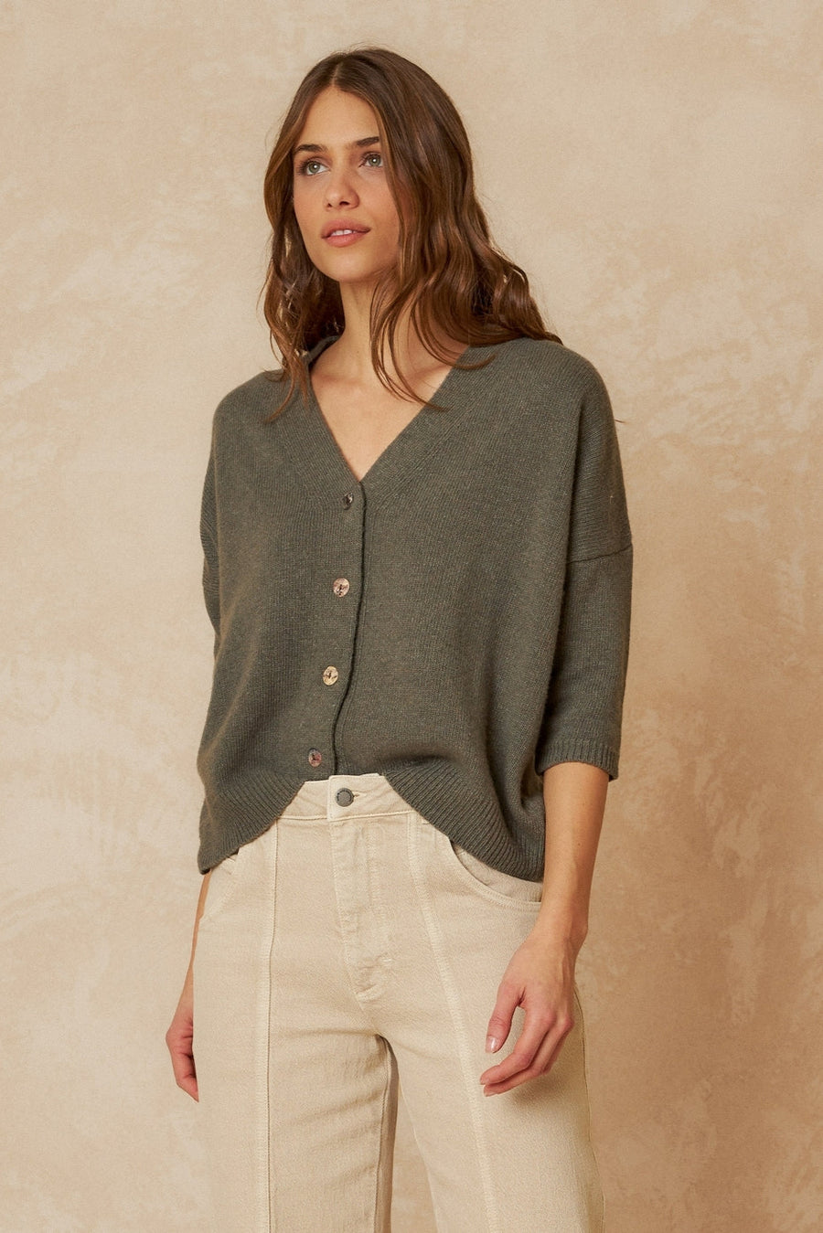 Khaki short sleeve wool cardigan with front buttons, dropped shoulder and ribbed hem and cuffs. 