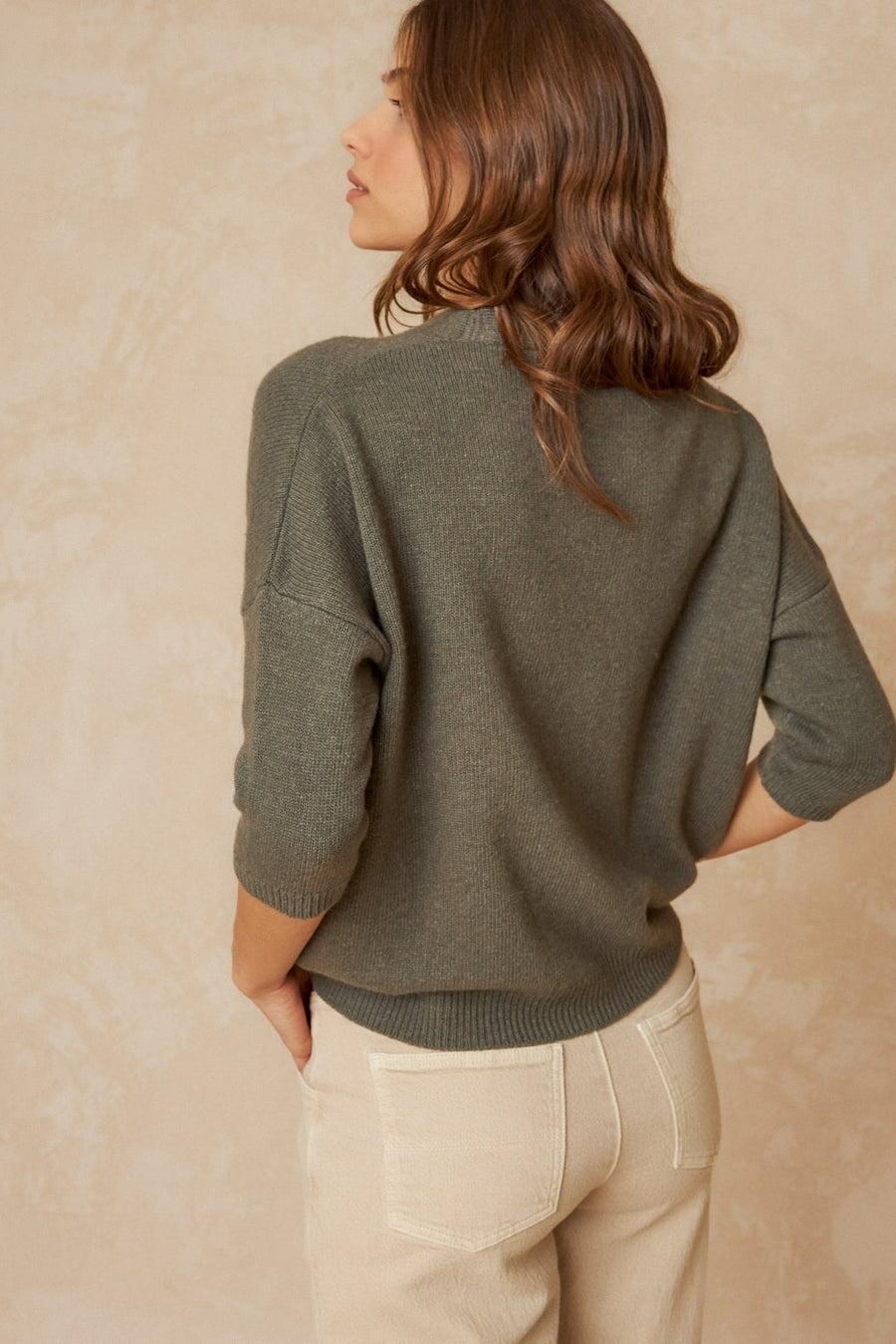 Khaki short sleeve wool cardigan with front buttons, dropped shoulder and ribbed hem and cuffs. 