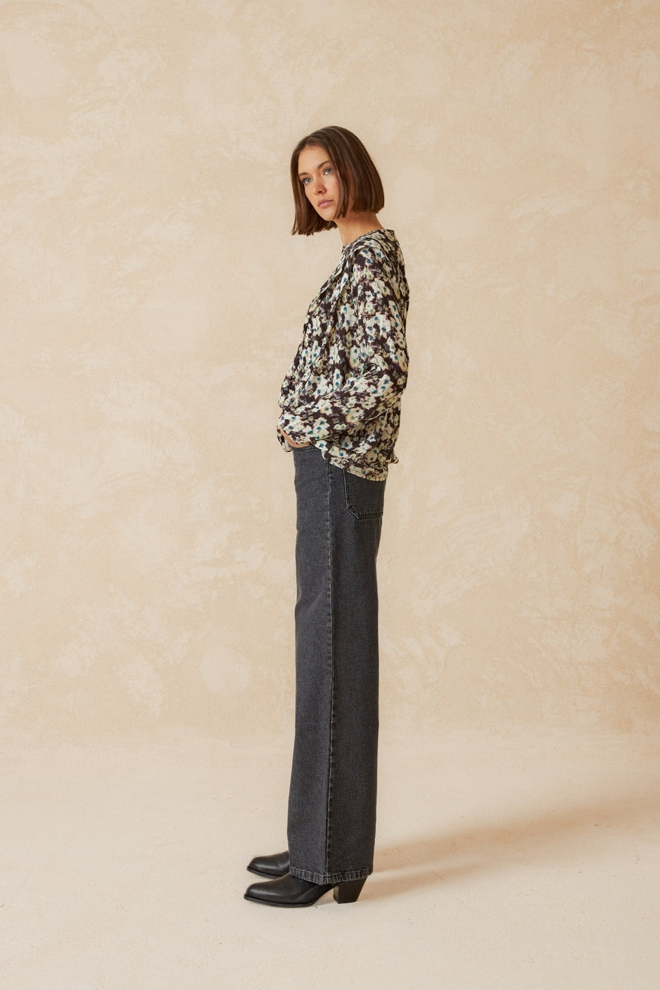 Wide leg mid rise grey jean side profile. 
