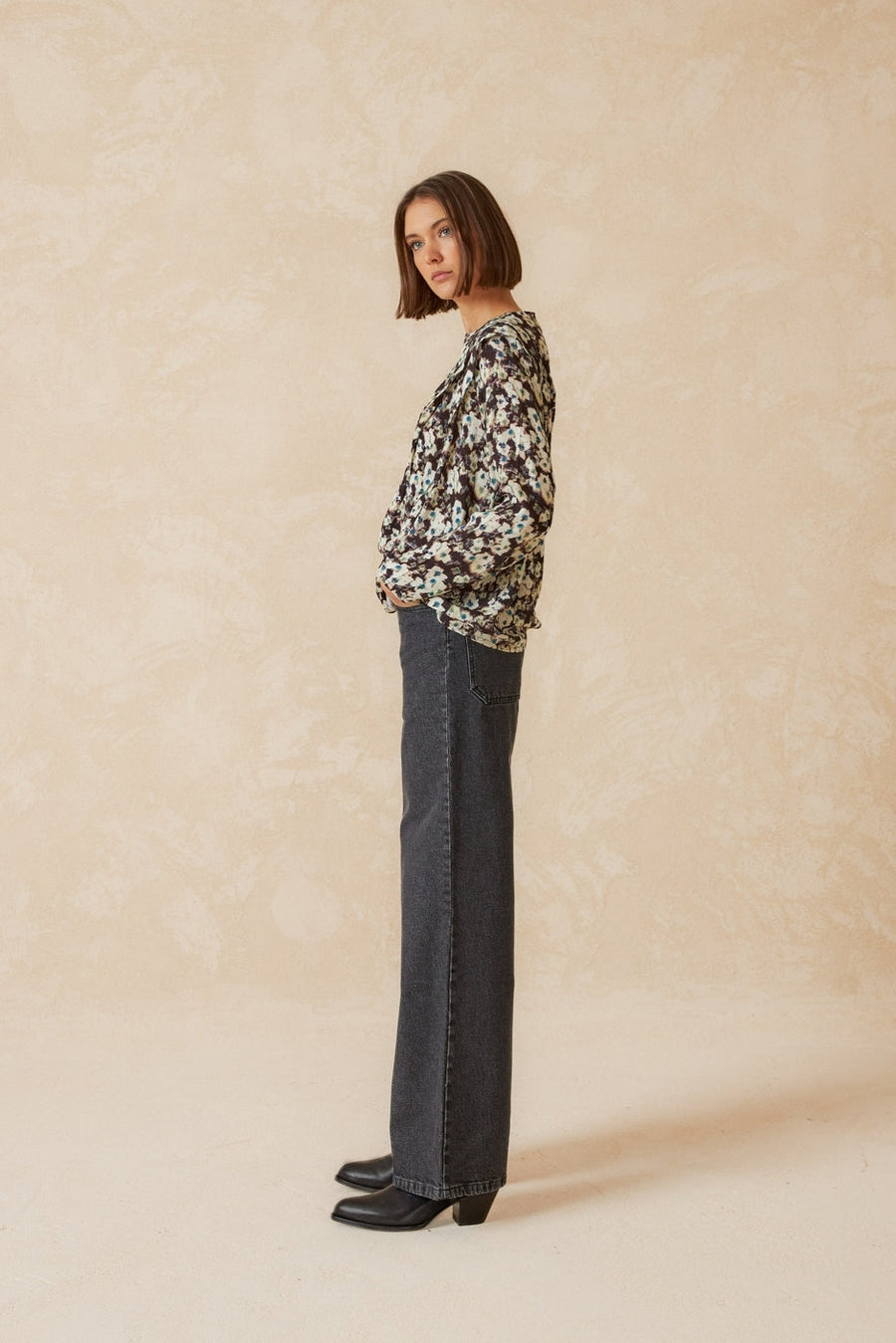 Wide leg mid rise grey jean side profile. 